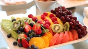 A fruit platter with various fruits including kiwi, strawberries, blueberries, raspberries, grapes, and watermelon slices. - Almayer La Locanda della Bicicletta (Gaeta)