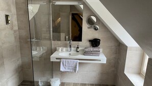 A modern bathroom with a glass-enclosed shower, a white vanity with a mirror, and a towel rack. - Logis Relais Saint Vincent (Ligny-le-Chatel)