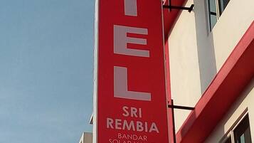 A hotel sign with the name "HOTEL SRI REMBIA BANDAR SOLAR VALLEY CITY" and contact number "06 316 3833".