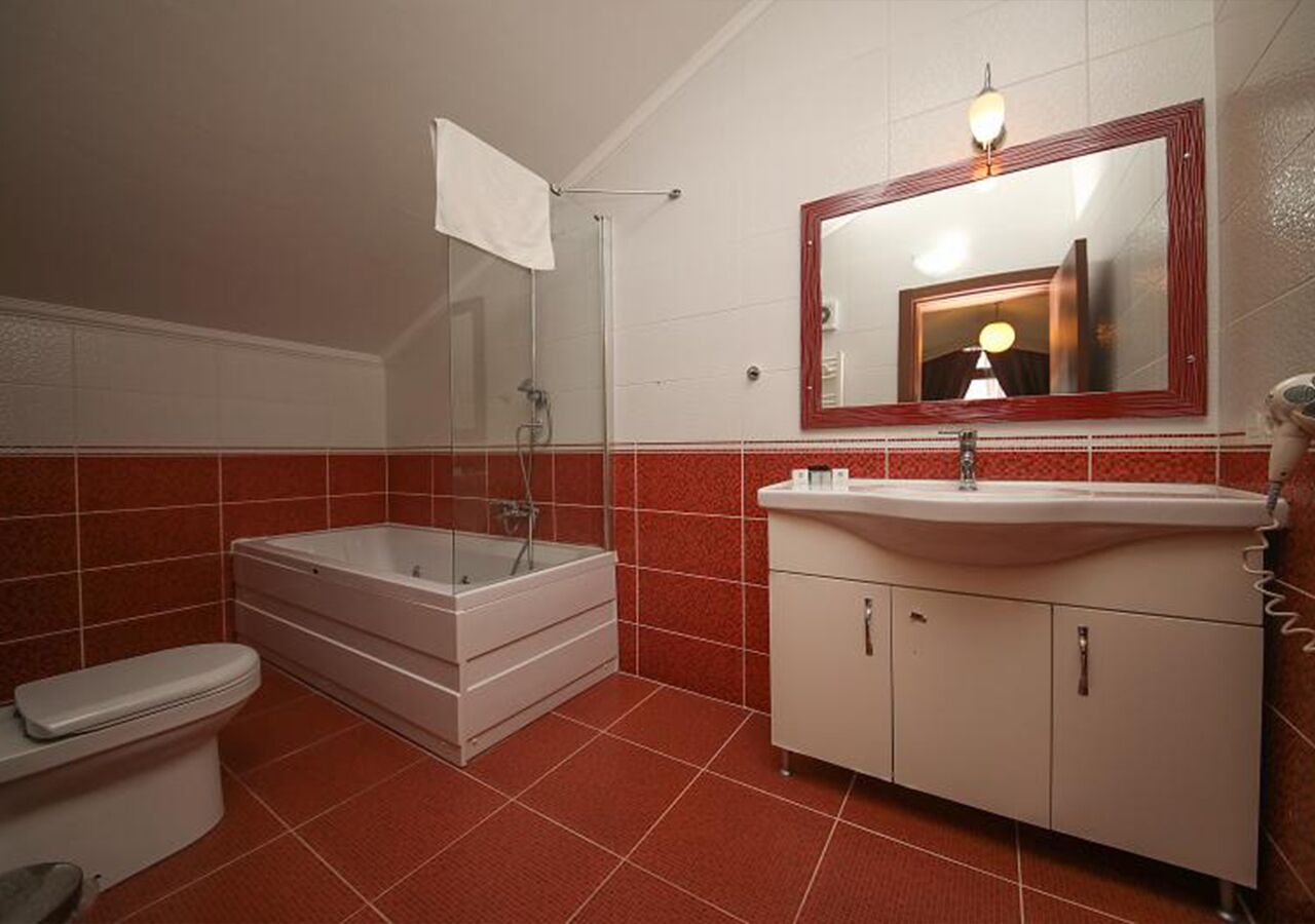 deluxe room, fireplace | bathroom | hair dryer, slippers, towels