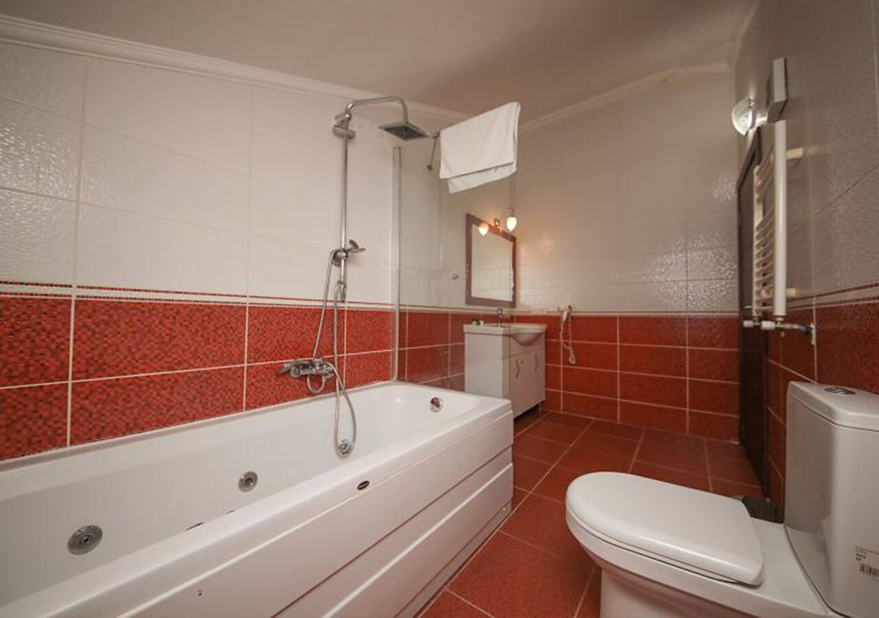 deluxe room, fireplace | bathroom | hair dryer, slippers, towels