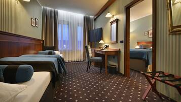 Deluxe Quadruple Room | In-room safe, individually decorated, desk, laptop workspace