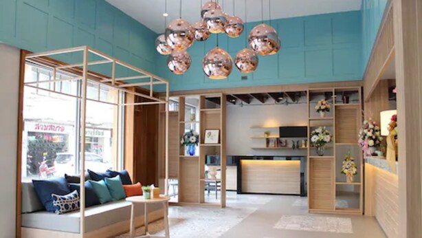 Un intérieur moderne avec un coin salon, des étagères en bois et un éclairage décoratif.