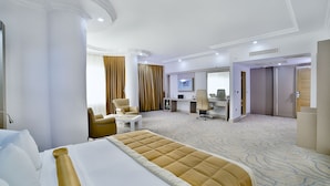 A hotel room with a large bed, a desk, a chair, and a computer. - Marathon Hotel (Elazig)