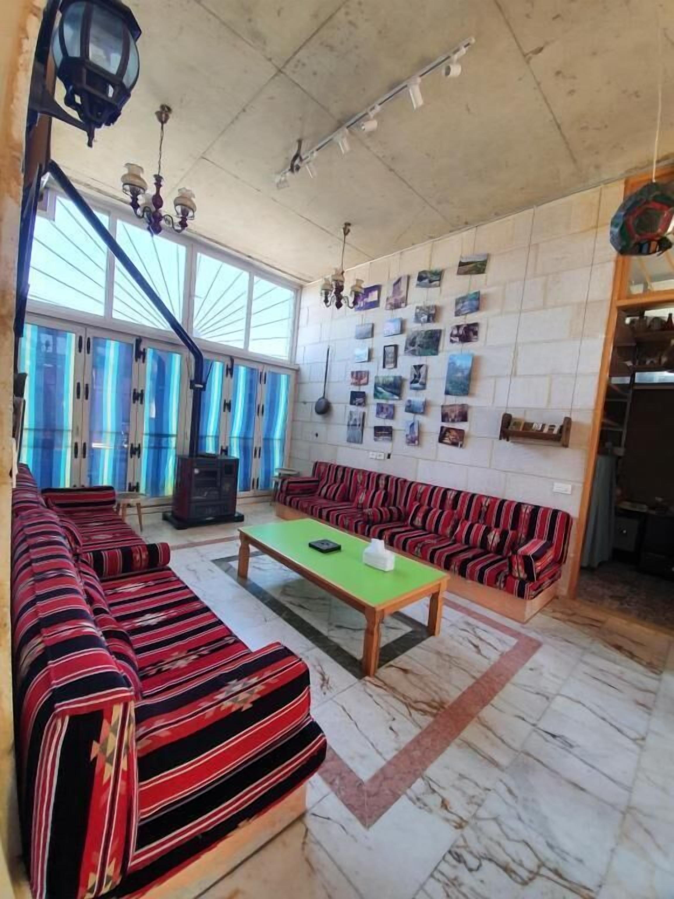 A living room with a sofa set, a coffee table, and a wall with pictures.