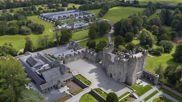 Experience the blend of old and new at this historic castle, surrounded by lush greenery and a serene landscape.