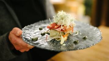 A person holding a plate with a food dish.