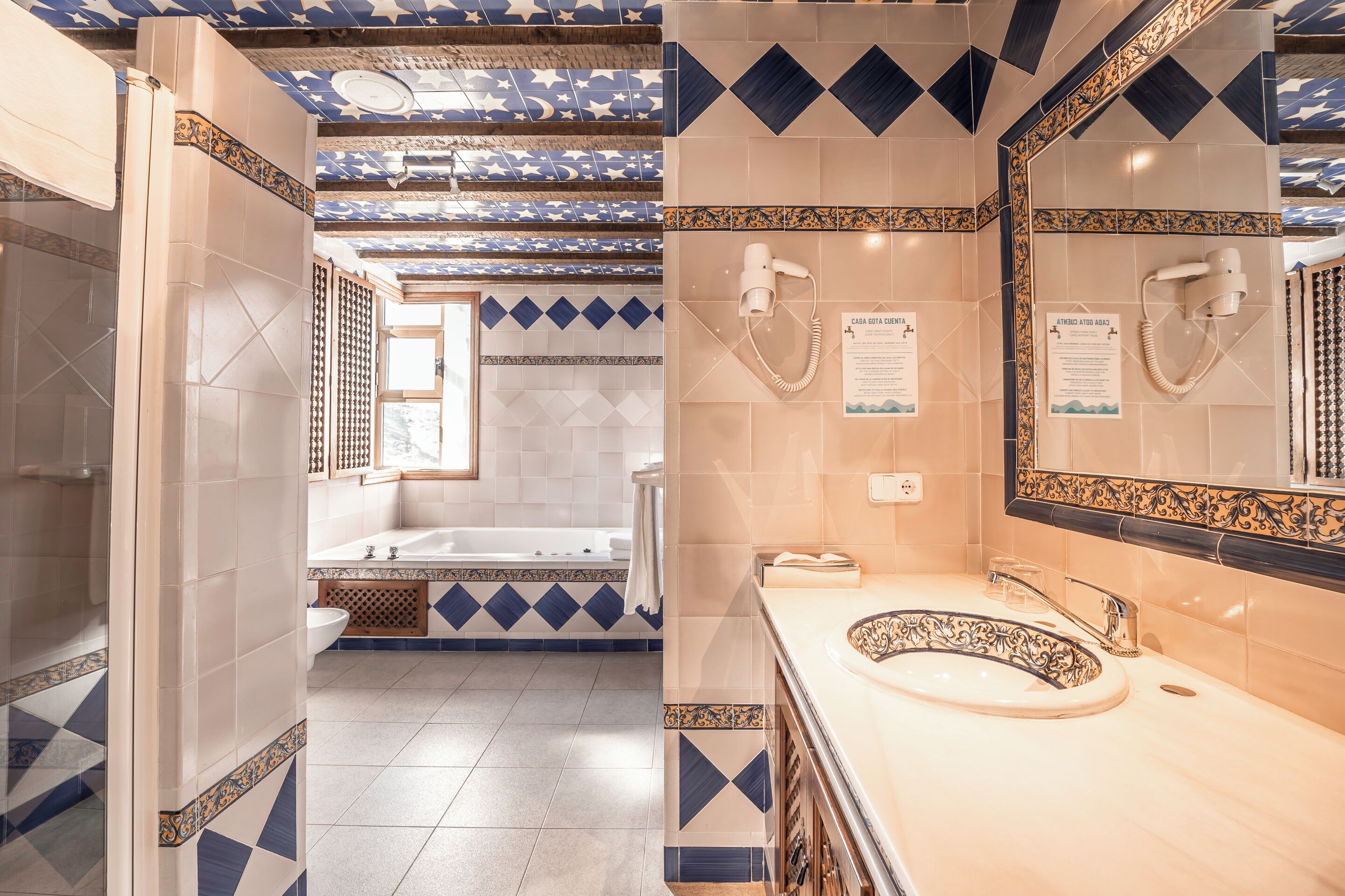 junior studio suite | bathroom | rainfall showerhead, eco-friendly toiletries, hair dryer, towels