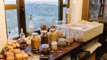 A breakfast buffet with various food items and condiments.