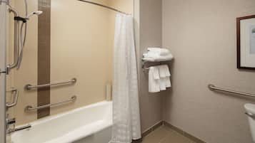 A bathroom with a bathtub, a shower with a glass door, and a toilet.