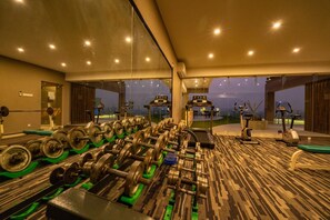 A gym with weightlifting equipment, treadmills, and exercise bikes. - Castle Salam (Khulna)