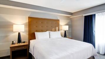 Premium bedding, desk, laptop workspace, blackout drapes