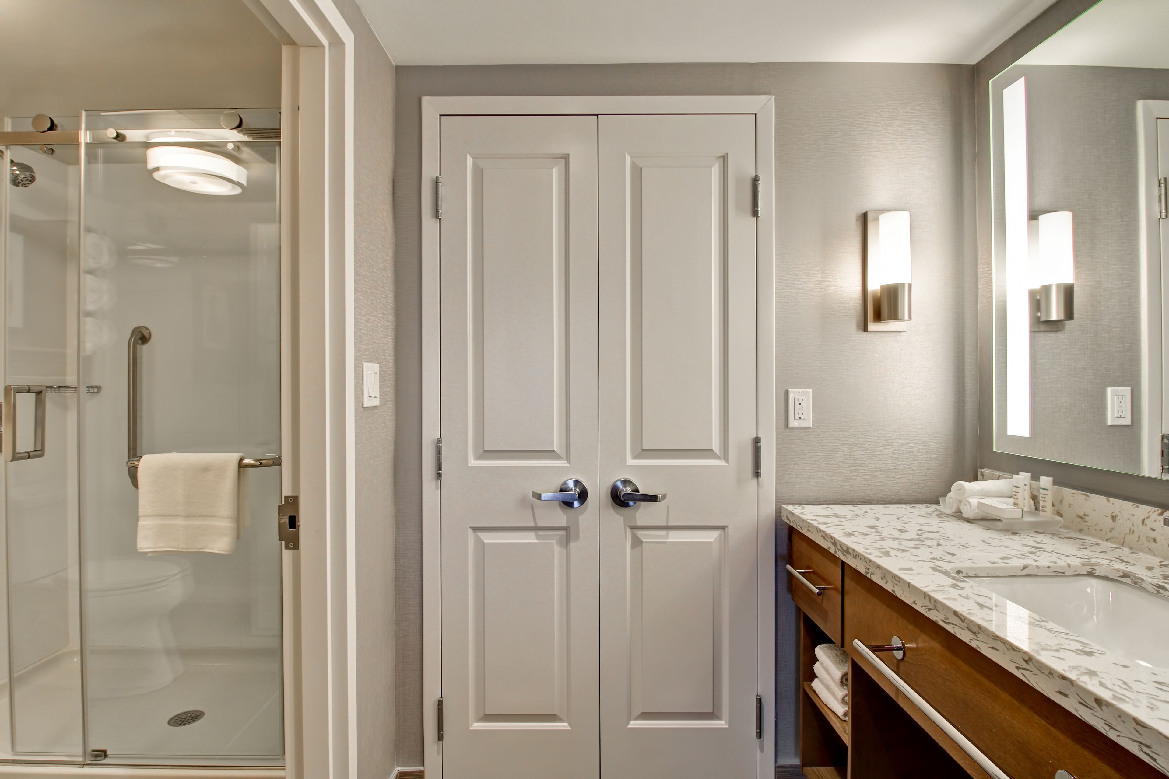 designer toiletries, hair dryer, towels