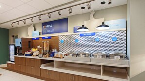 A breakfast buffet area with labeled sections for fruit, cereal, and hot food. - Holiday Inn Express and Suites King George- Dahlgren by IHG (King George)