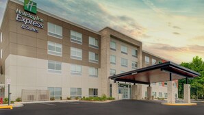 A Holiday Inn Express & Suites building with a modern design, featuring a flat facade, large windows, and a covered entrance. - Holiday Inn Express and Suites King George- Dahlgren by IHG (King George)
