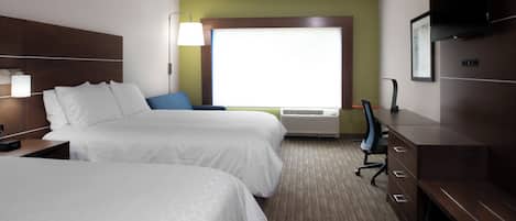 A hotel room with two beds, a desk, a chair, a television, and a window.