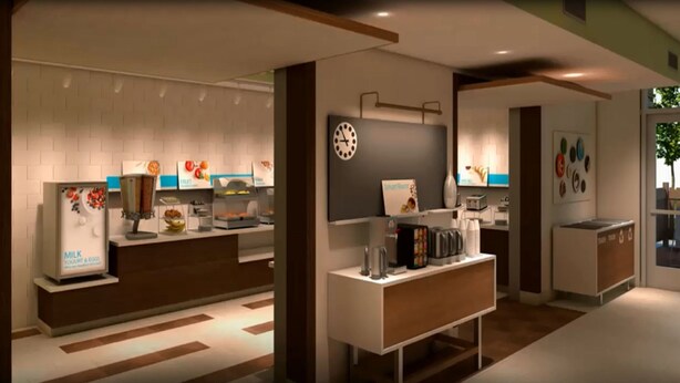 A modern reception area with a self-service kiosk, a clock, and a coffee station. - Holiday Inn Express and Suites Gettysburg by IHG (Gettysburg)
