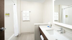 A modern bathroom with a shower, a sink, and a mirror. - Holiday Inn Express and Suites North Brunswick by IHG (North Brunswick)