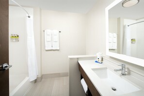 A modern bathroom with a shower, a sink, and a mirror. - Holiday Inn Express and Suites North Brunswick by IHG (North Brunswick)