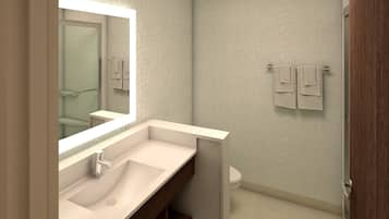 Un baño moderno con un espejo grande, un lavamanos y un inodoro.