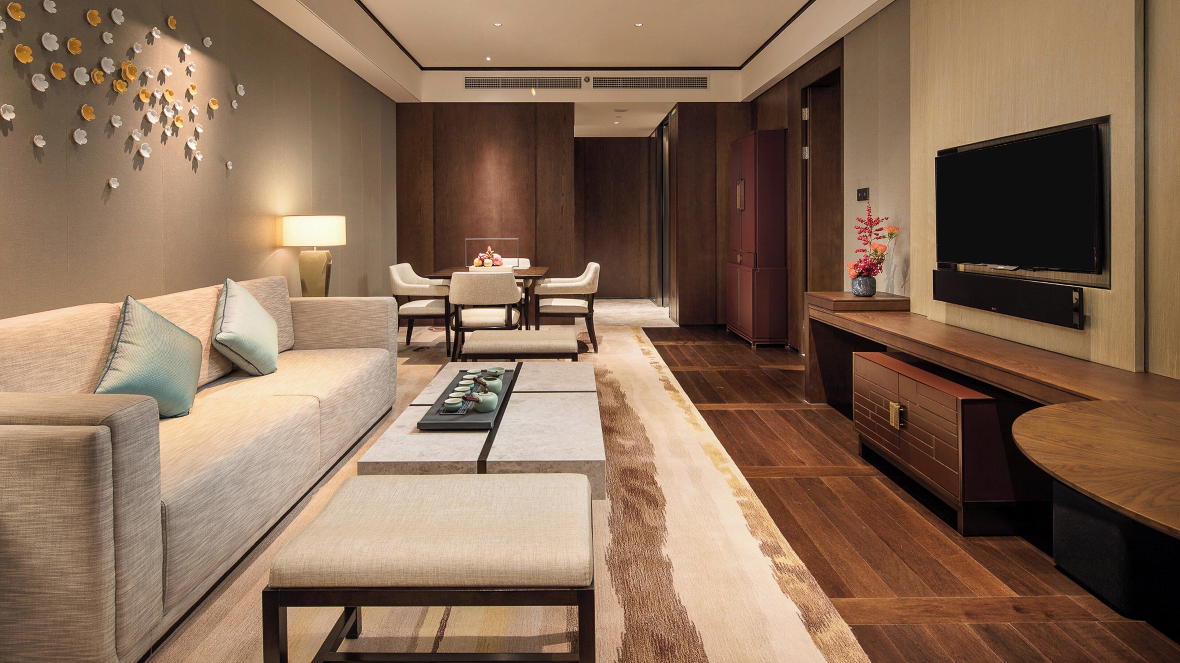 A modern living room with a sofa, coffee table, and TV.