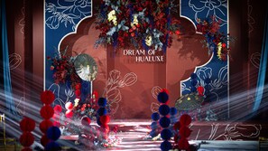 A stage with a floral arrangement and the text "DREAM OF HUALUX". - HUALUXE Xiamen Haicang Harbour View by IHG (Xiamen)