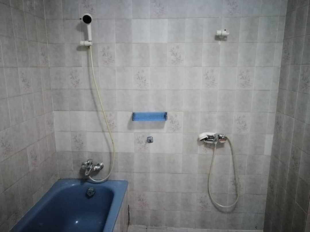 A bathroom with a bathtub, a shower, and a toilet.
