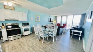 A compact living space with a kitchenette, dining area, and seating area. - Ocean City 2BR Oceanfront Condo - Bay Views, Pools, Ice Rink & More! (Ocean City)