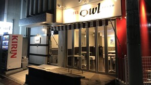 A restaurant named "The Owl" with a modern design, featuring a black and white striped awning, glass doors, and a visible seating area inside. - HOTEL OWL Tokyo (Tokyo)