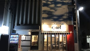 A hotel entrance with a sign reading "TEL OWL" and a vending machine labeled "KIRIN" outside. - HOTEL OWL Tokyo (Tokyo)