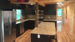 A modern kitchen with granite countertops, stainless steel appliances, and wooden cabinetry. - KastleRock Brand new 5 min to Slopes PoolTable Jacuzzi VIEWS PRIVATE sleep15 (Banner Elk)