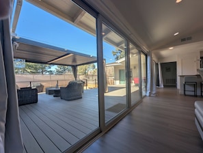 A spacious indoor area with a large sliding glass door leading to an outdoor deck. - CENTRALLY LOCATED WITH HOT TUB: Zen Garden - Your Sedona Oasis Awaits (Sedona)