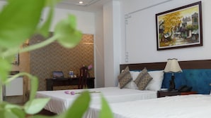 A hotel room with two beds, a desk, and a painting on the wall. - Maison D'Hanoi Hotel (Hanoi)