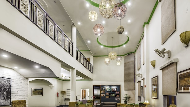 A spacious lobby with a reception desk, seating area, and decorative lighting. - Hotel Ranthambore Regency (Sawai Madhopur)