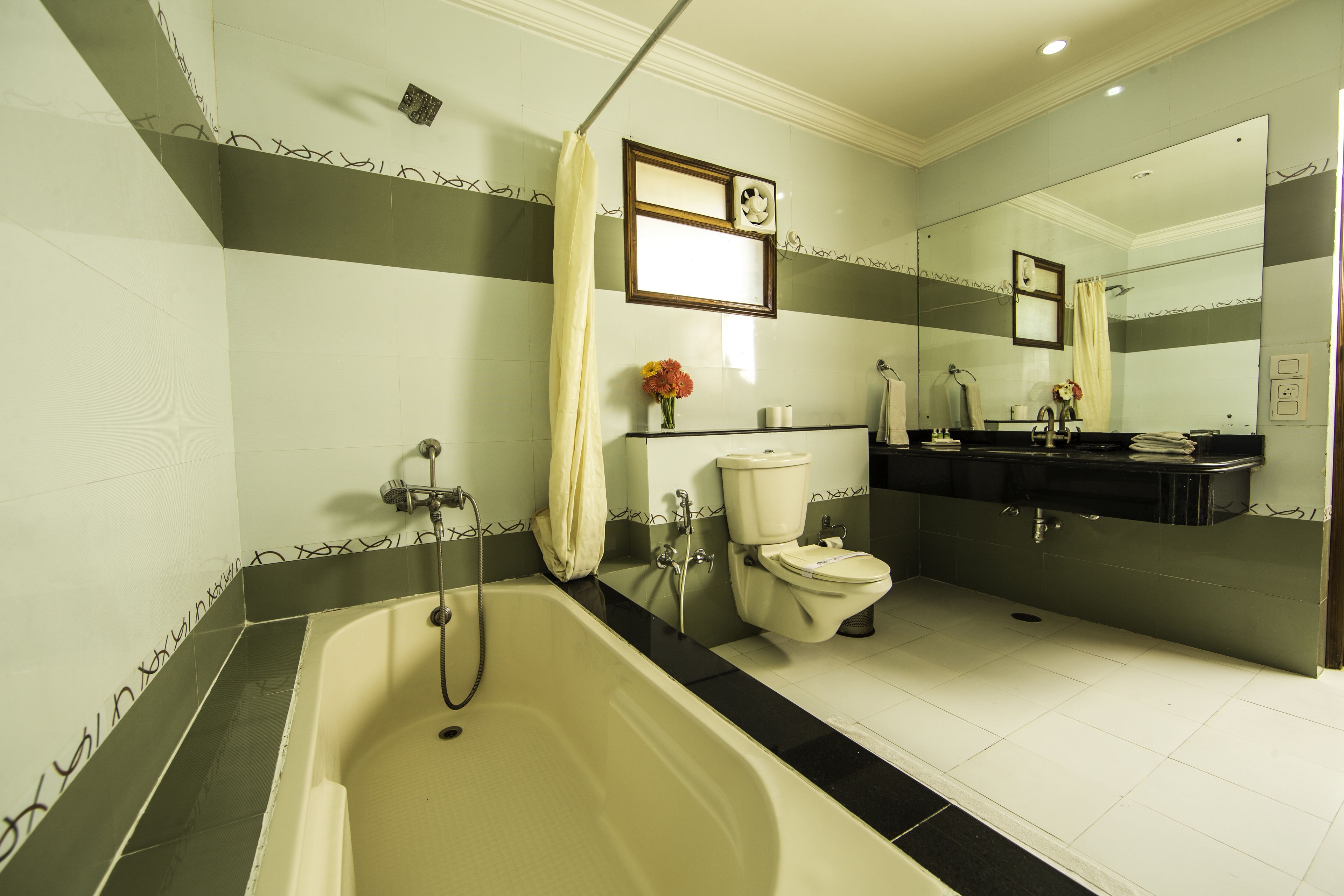 A bathroom with a bathtub, toilet, and sink.