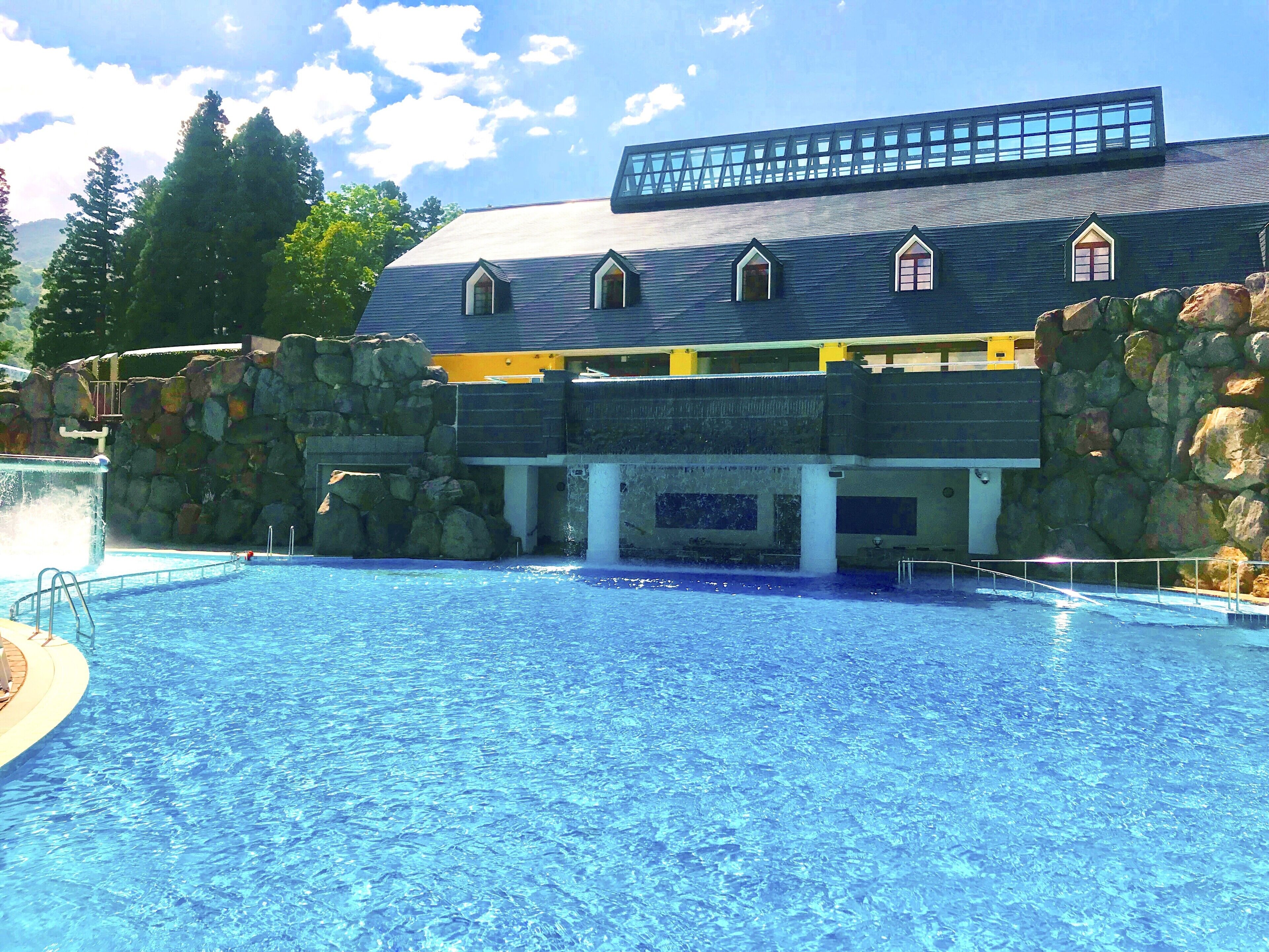 A swimming pool with a building in the background.