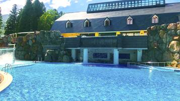 A swimming pool with a building in the background.