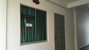A reception area with a 'RECEPTION' sign, a 'Welcome' sign above, and a 'TERIMA KASIH' sign thanking guests. - Lyaa Resthouse (Langkawi)