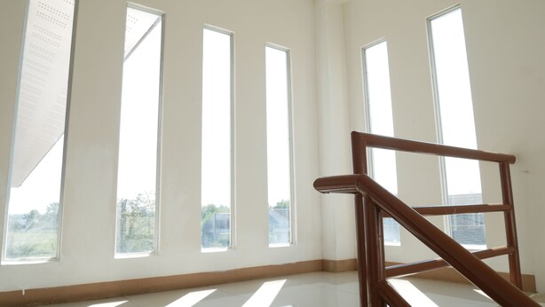 A room with large windows, a wooden staircase, and a tiled floor. - Fang Villa Hotel (Fang)