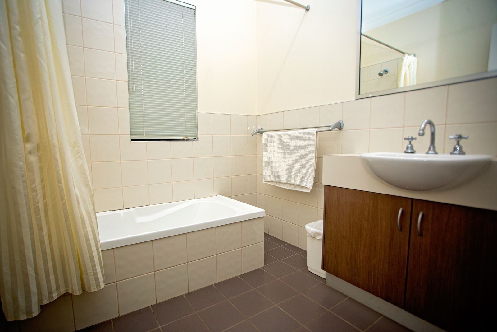 A bathroom with a bathtub, a sink, and a toilet.