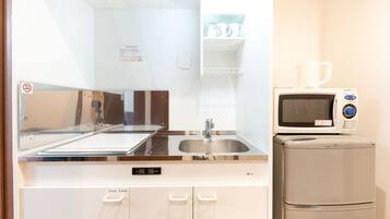 Twin Room | Private kitchen | Fridge, microwave