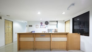A reception desk with a sign, a clock, and framed certificates on the wall. - Tang City Hotel, Petaling Street, Merdeka PNB 118 Tower (Kuala Lumpur)