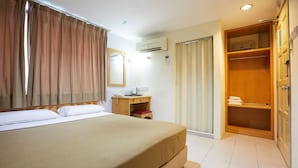 A hotel room with a bed, a desk, an air conditioning unit, a wardrobe, and a bathroom. - Tang City Hotel, Petaling Street, Merdeka PNB 118 Tower (Kuala Lumpur)