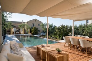 Outdoor pool, an infinity pool, pool umbrellas, pool loungers