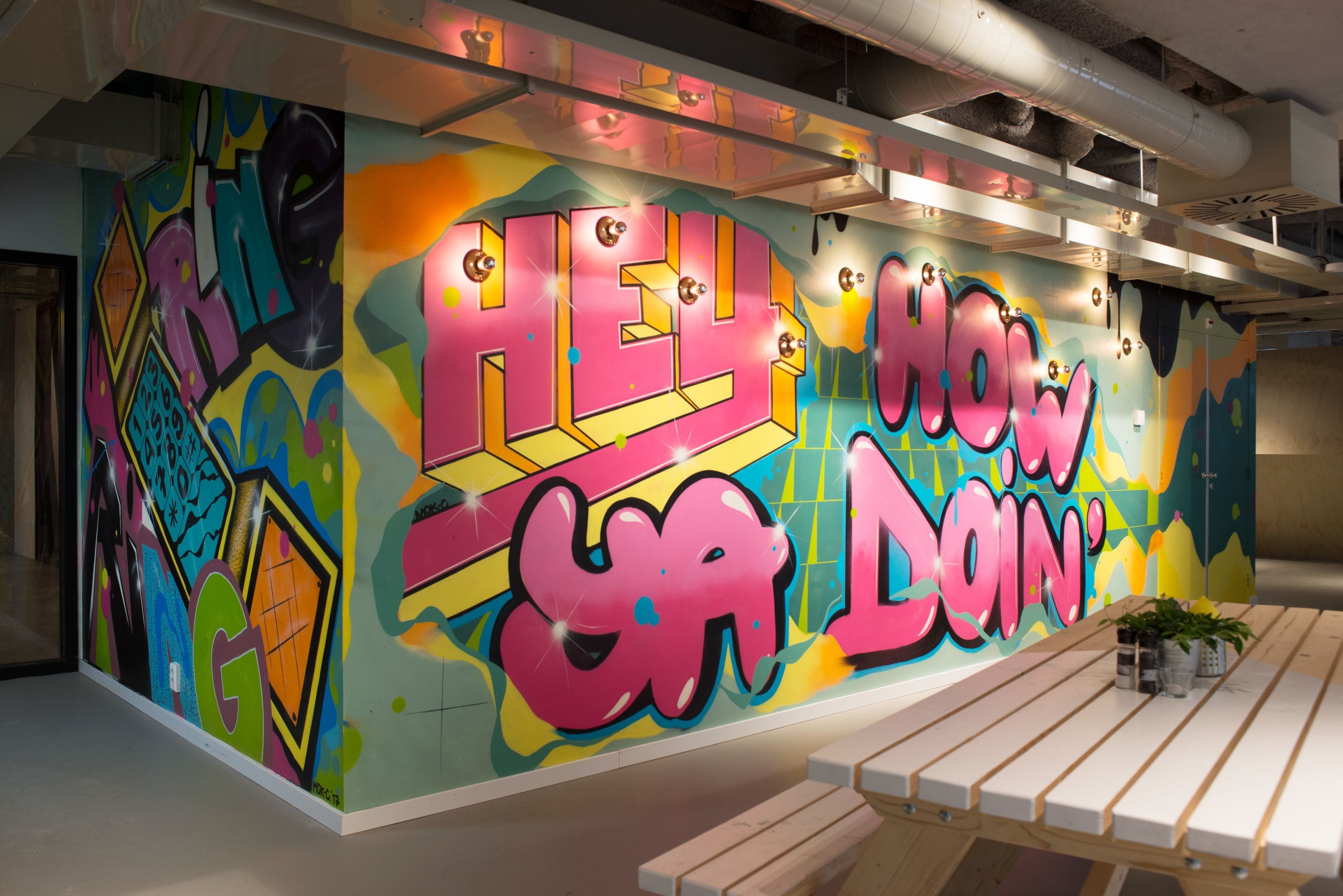 A vibrant graffiti wall with large, colorful letters spelling "HELLO" and "DON'T".