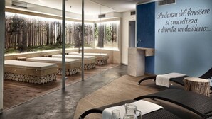 A spa area with stone benches, a glass wall with a forest view, and a wall with motivational text. - Color Home Suite Apartments (Predazzo)