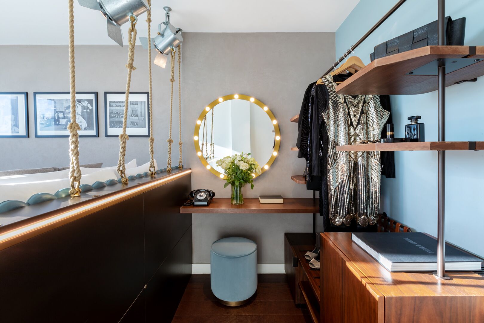 A modern vanity with a mirror, vanity lights, and a wooden vanity table.