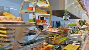 A buffet with various food items and a decorative metal structure. - Wanjiali International Hotel (Changsha)