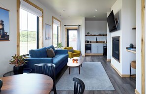 Deluxe Suite, 1 Bedroom, Kitchen | Living area | 50-inch flat-screen TV with cable channels, TV, fireplace - Boardwalk Cottages (Long Beach)