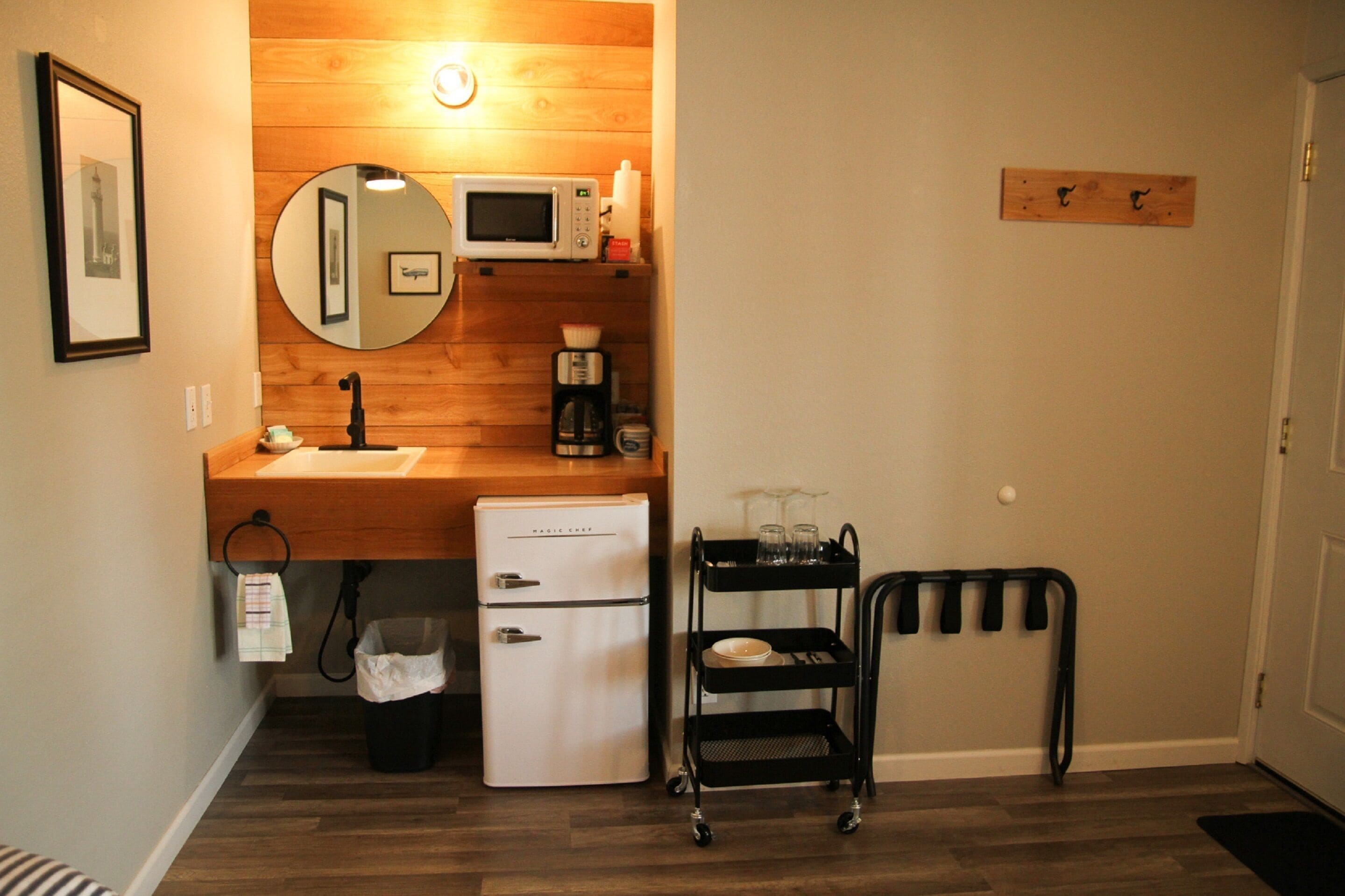 A compact kitchenette with a microwave, coffee maker, and a small refrigerator.